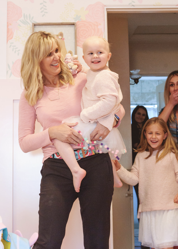 Susan Wintersteen, founder of Savvy Interiors and its nonprofit arm, Savvy Giving by Design, introduces a girl to her newly redesigned bedroom.